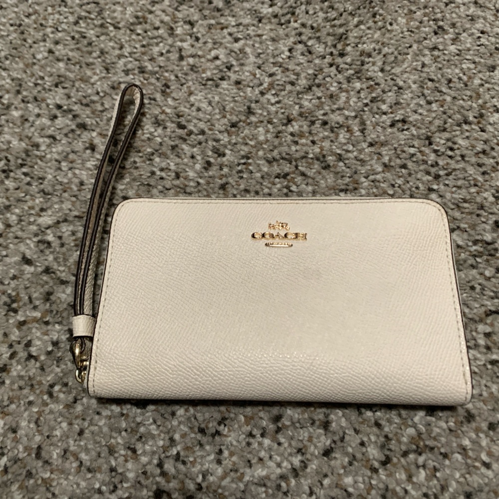 Small cream COACH wristlet wallet